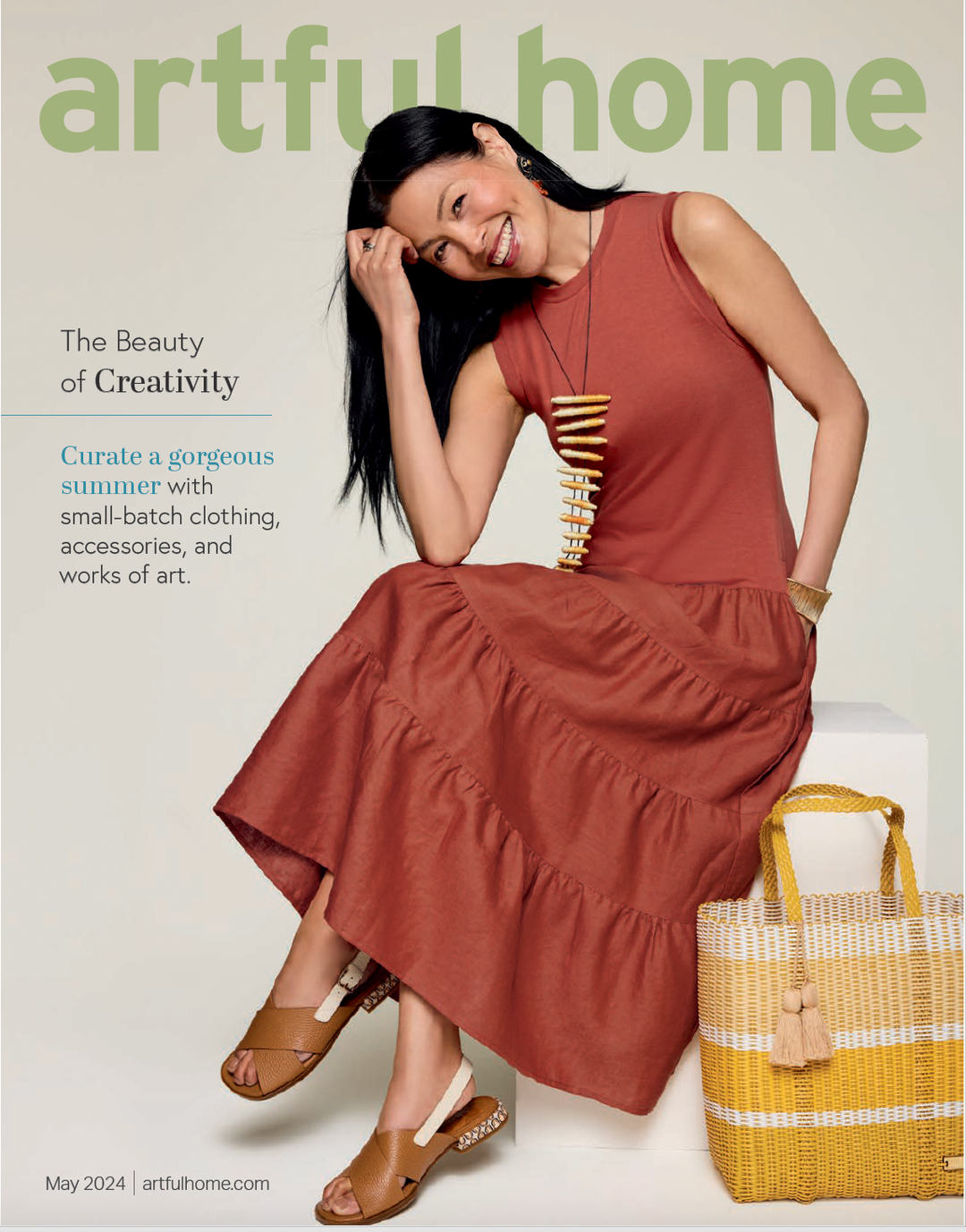 cover of Artful HOme May 2024 catalog featuring women in cute sun dress next to an ixoq cesta recycled plastic tote